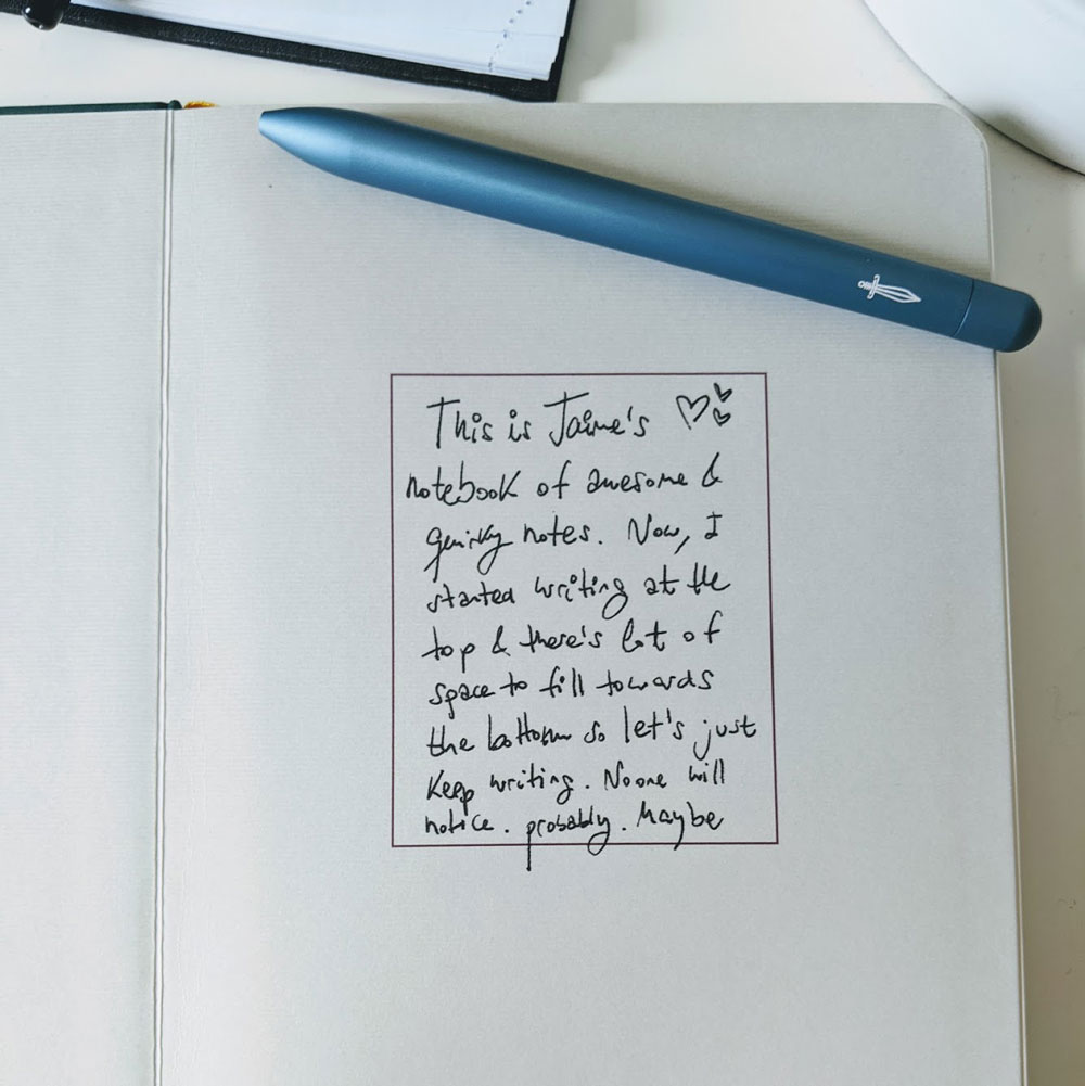 The first page of a baronfig notebook and a blue pen. There's a note that says: This is Jaime's notebook of awesome and quirky notes.